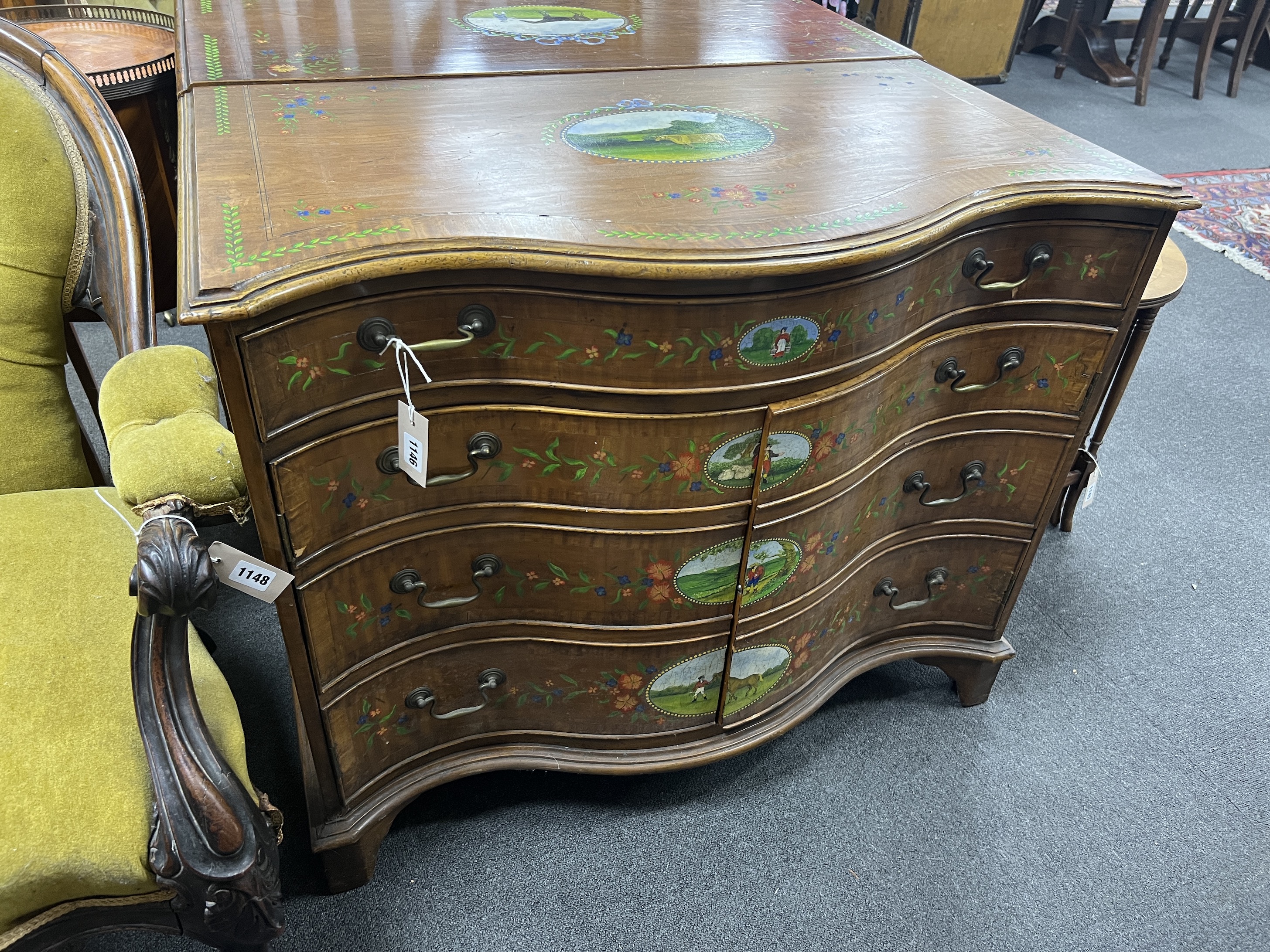 A George III style painted satinwood serpentine chest with part dummy drawer front, width 91cm, depth 48cm, height 75cm